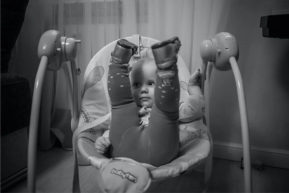 a baby lying in a comfortable baby swing